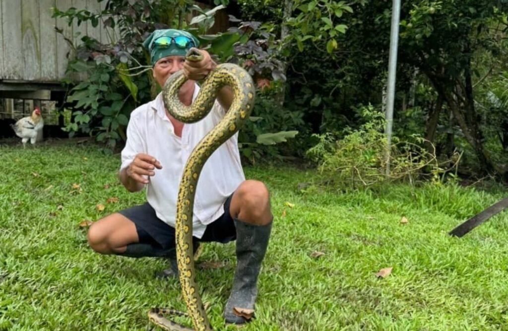 A serpent is handled by our brave guide!